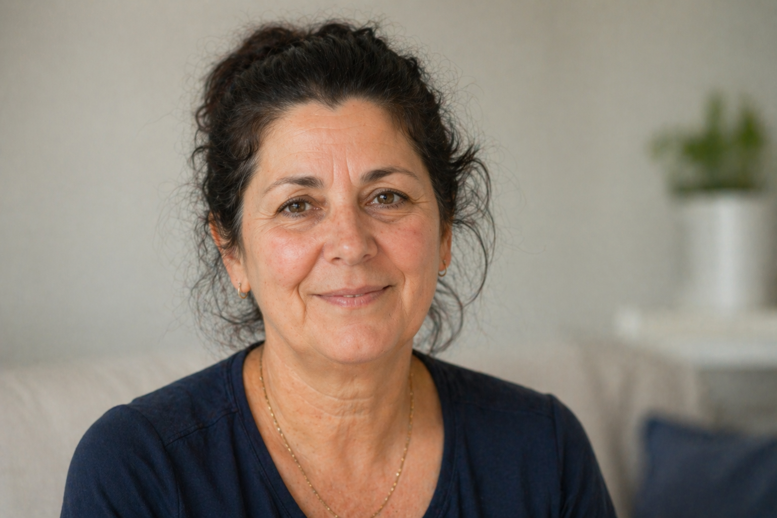 Susan smiling softly in a blue top